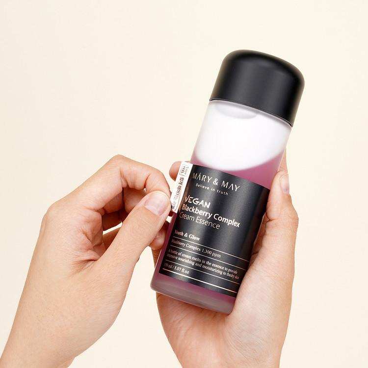 Close up of combined cream essence texture on fingertip