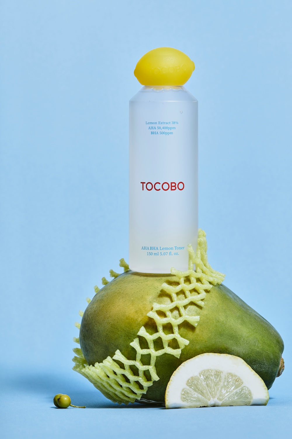 Toner bottle held between two fingers