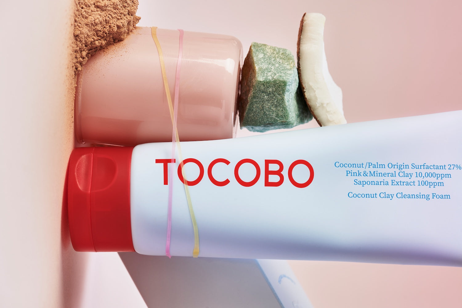 Cleansing foam tube displayed with a washcloth flatlay