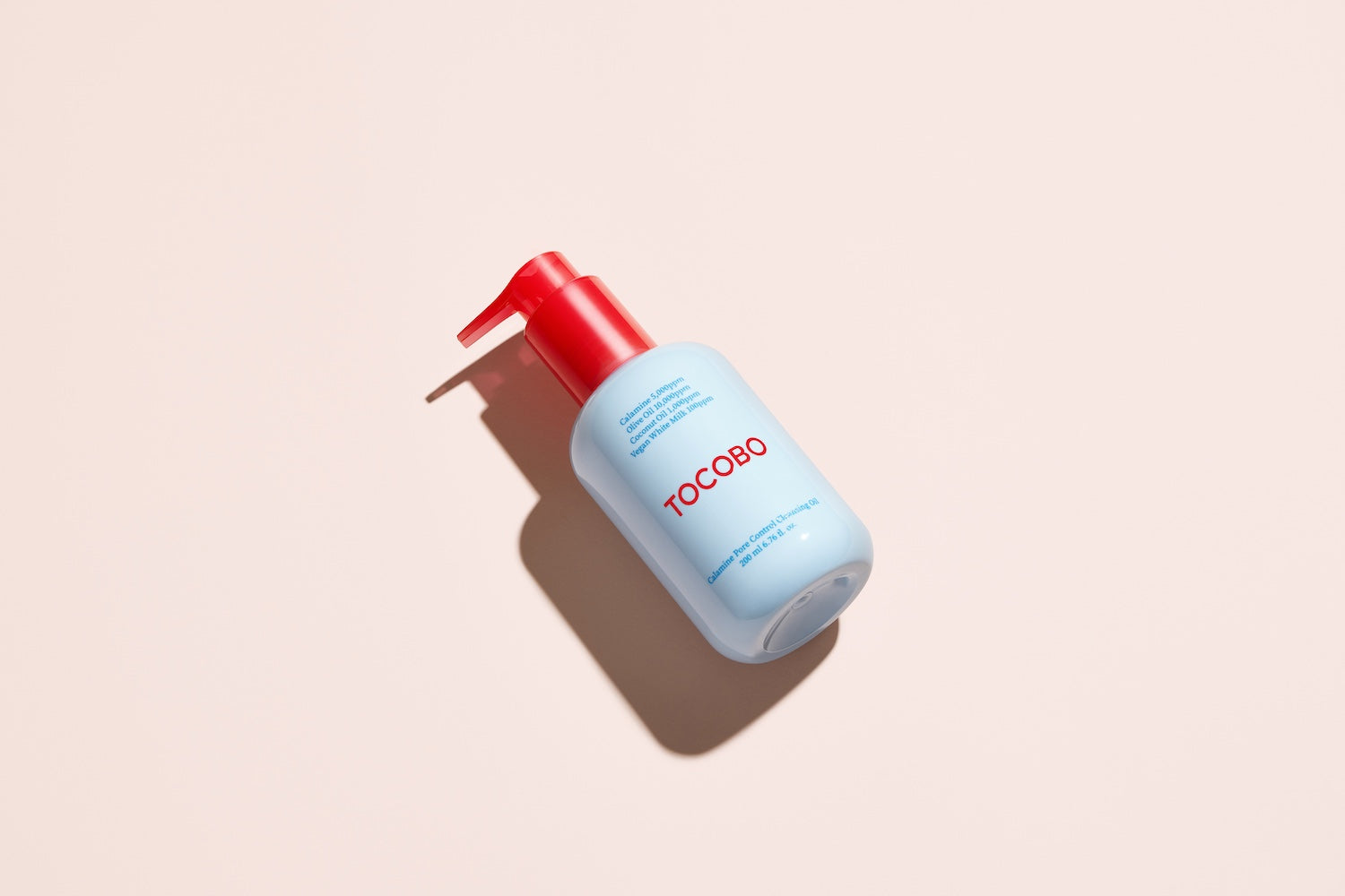 Cleansing oil bottle photographed against neutral background