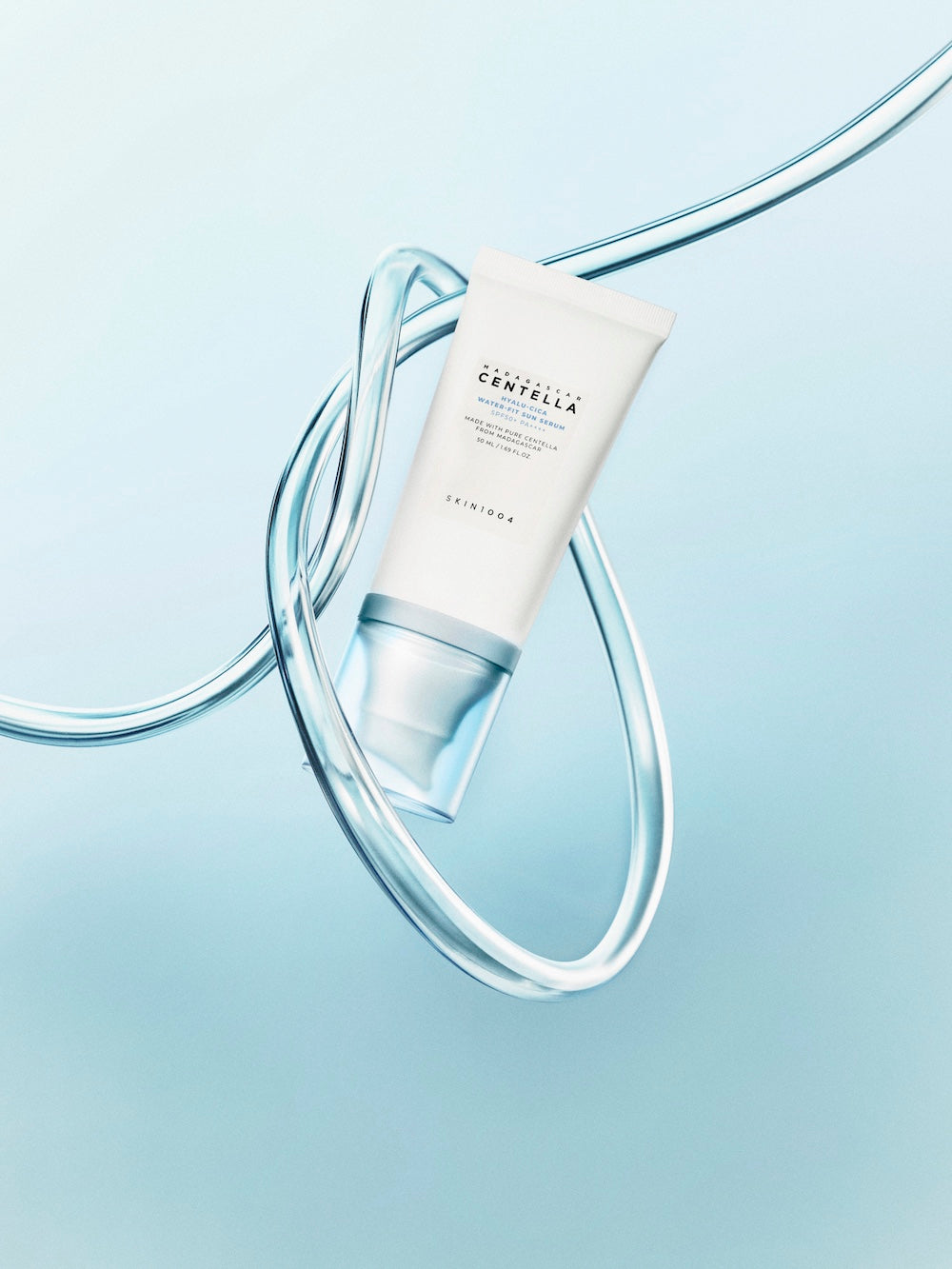 Sun serum bottle with cap resting beside it
