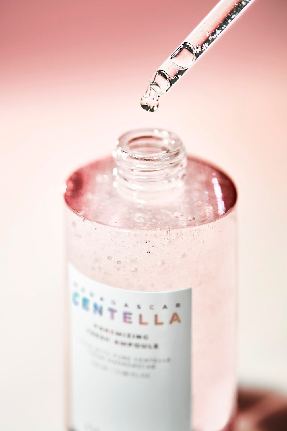 Ampoule bottle next to toner for routine flatlay