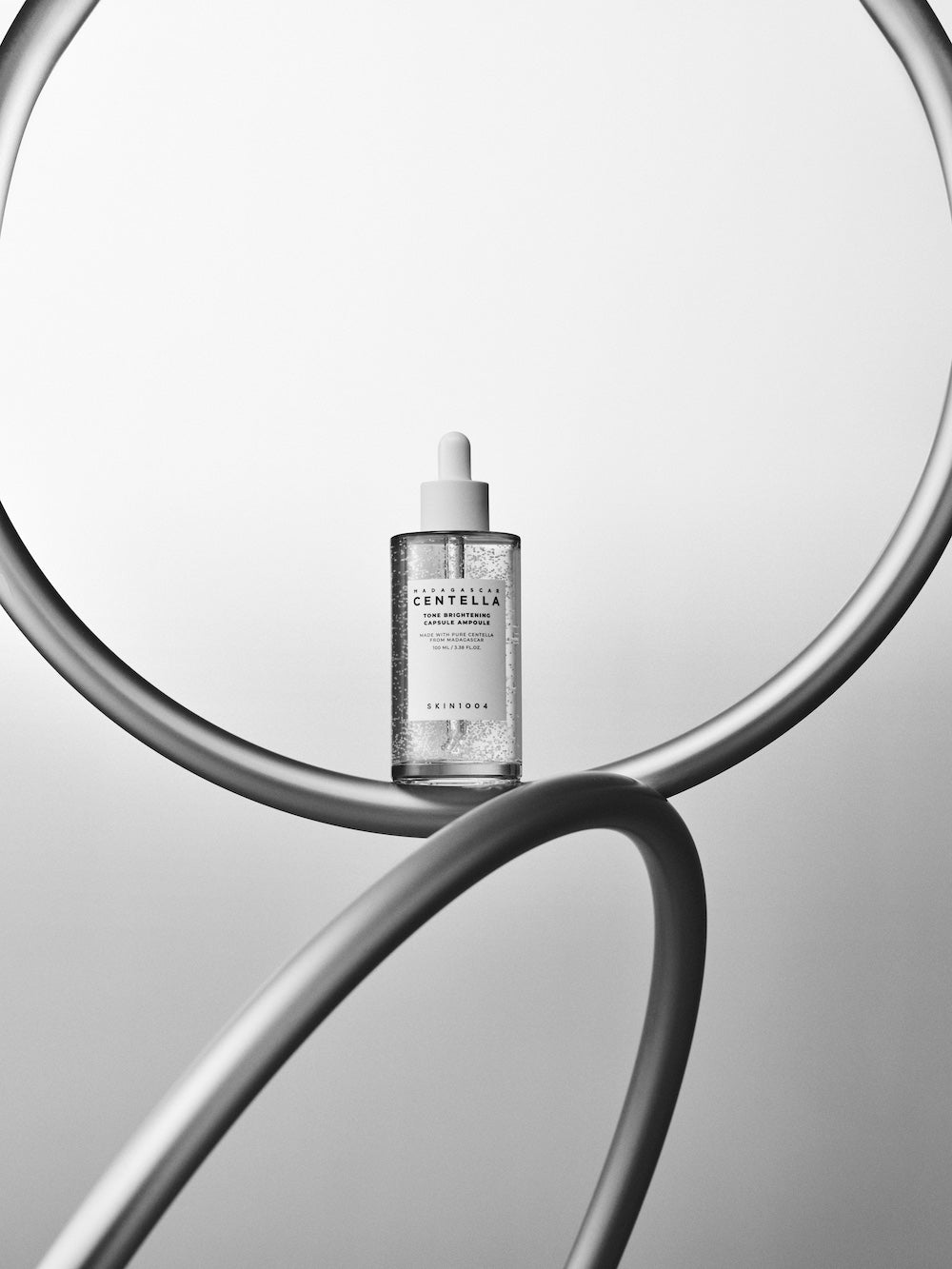 Ampoule bottle and box together on flat surface