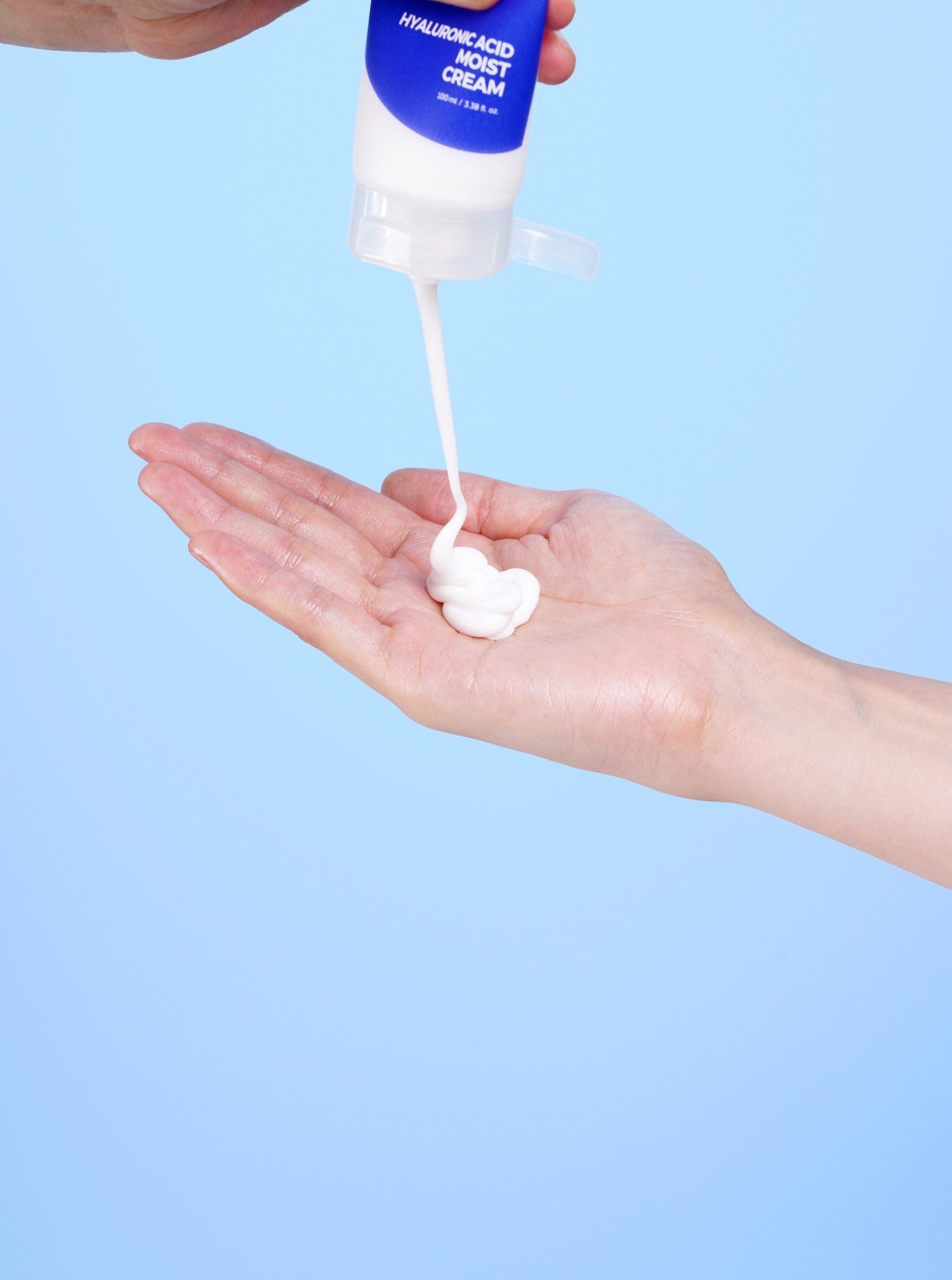 Model massaging Isntree Hyaluronic Acid Moist Cream into dry skin