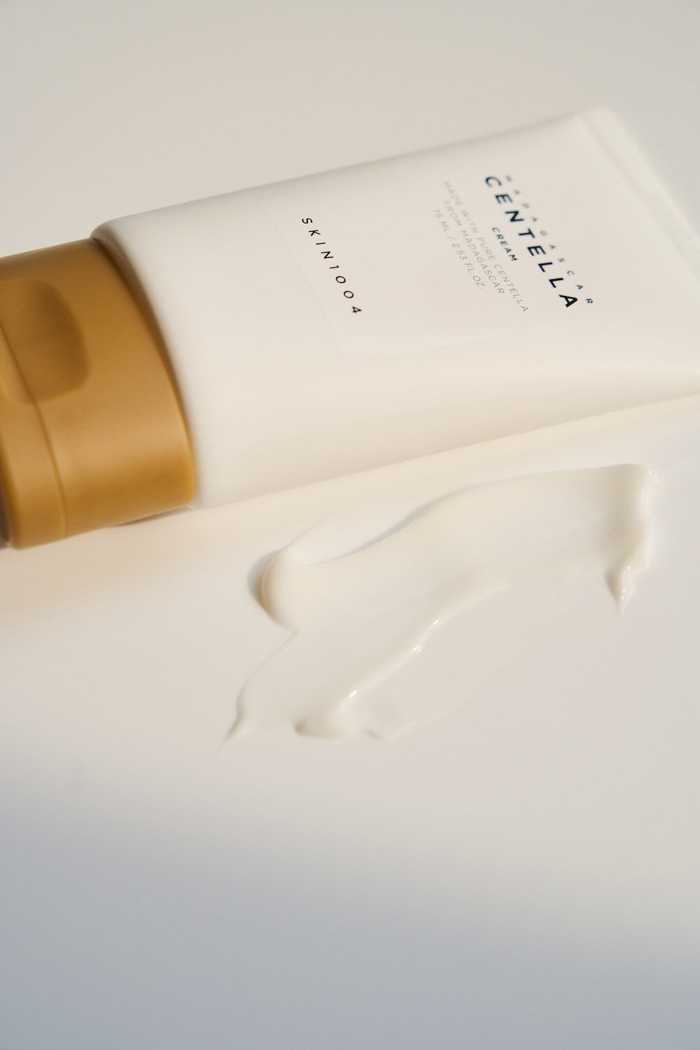 Cream jar photographed on marble surface