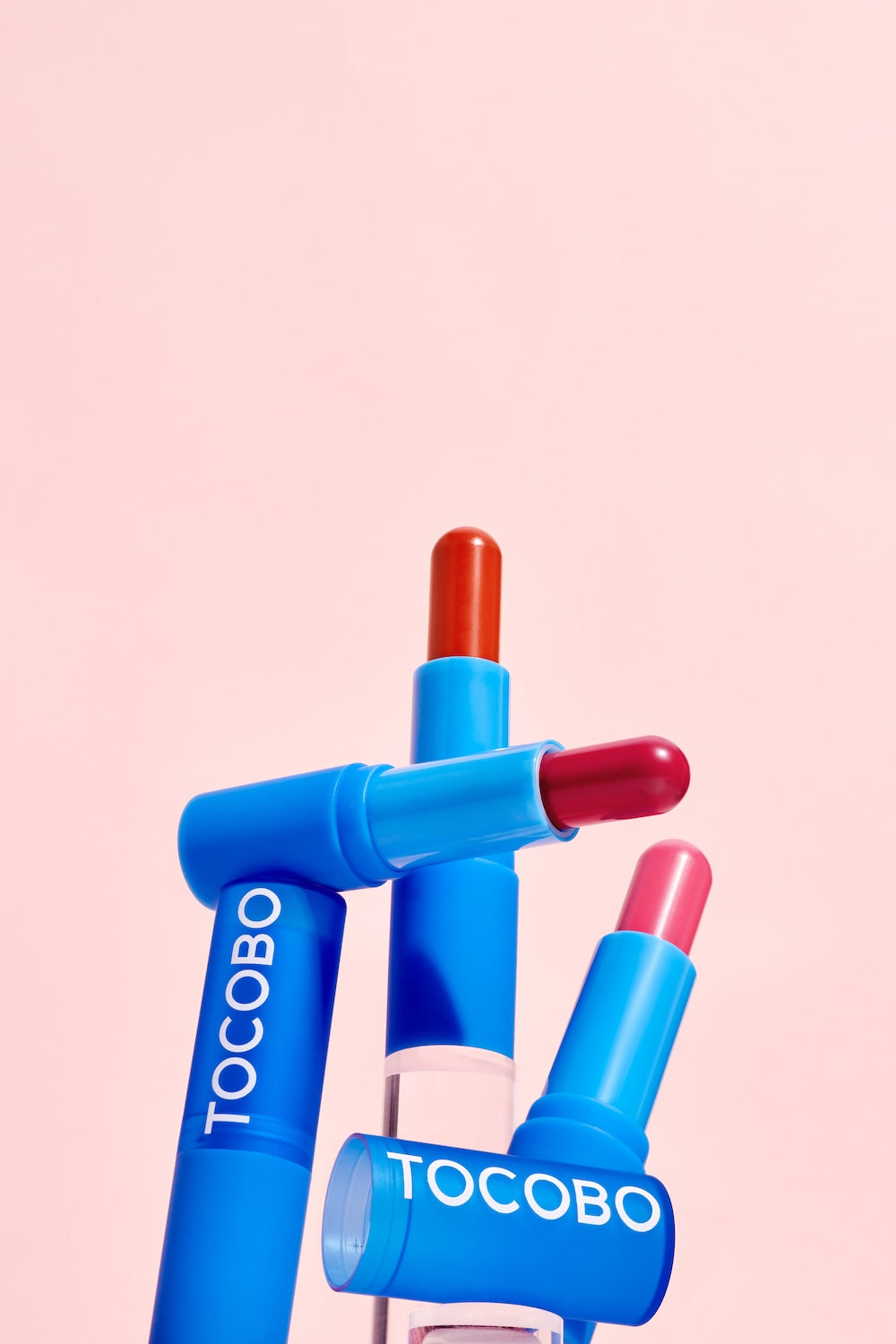 Lip balm tube next to other TOCOBO products
