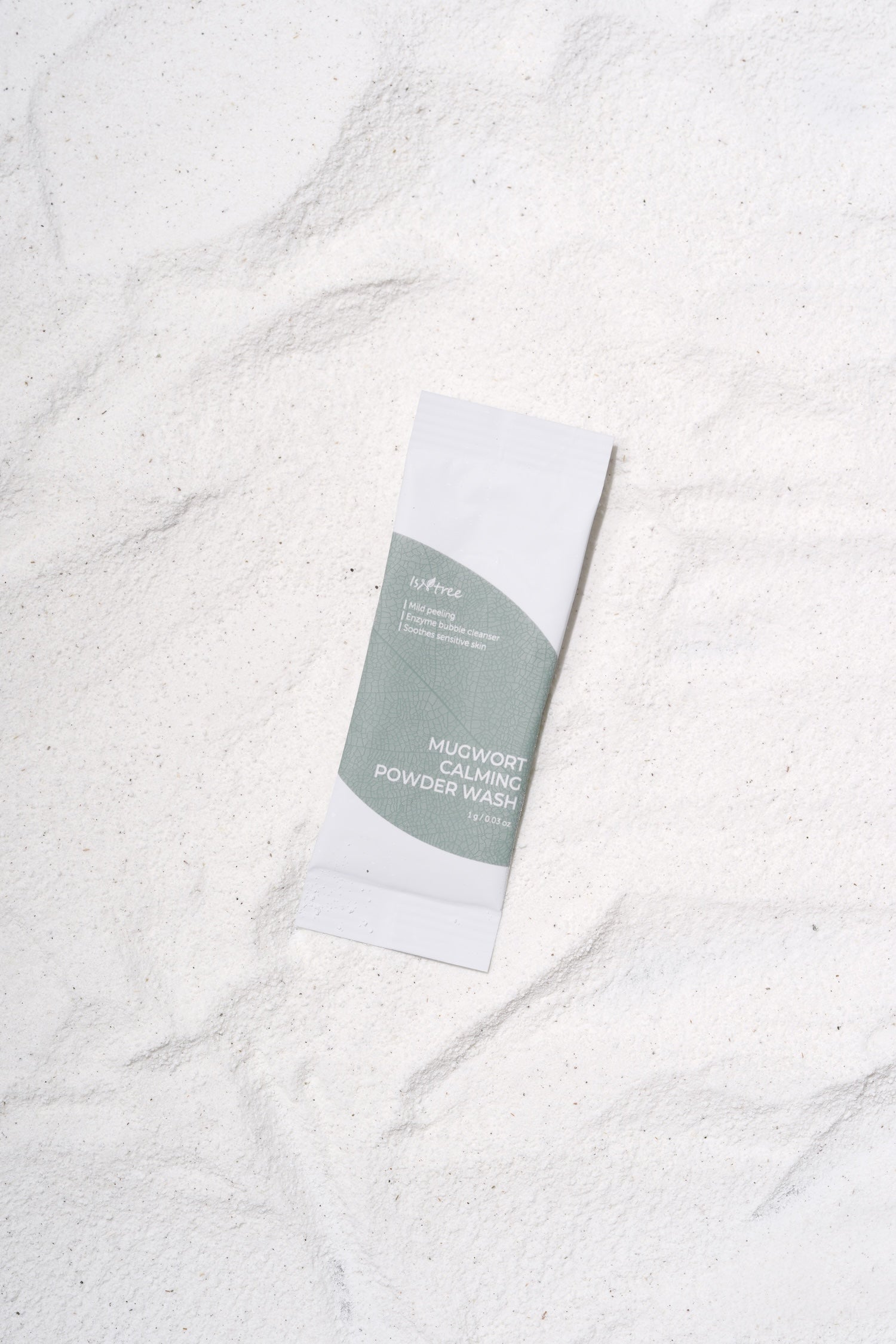 Foam from mugwort powder wash being massaged onto face