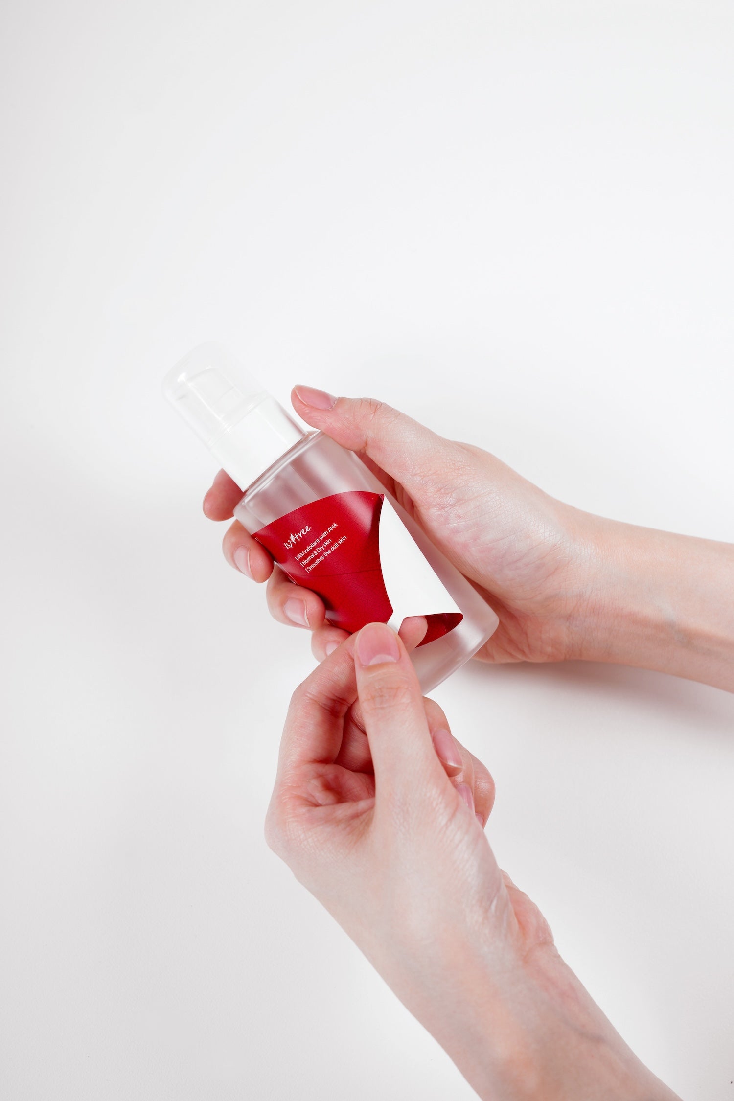 Close up of essence dispensed into cap for application
