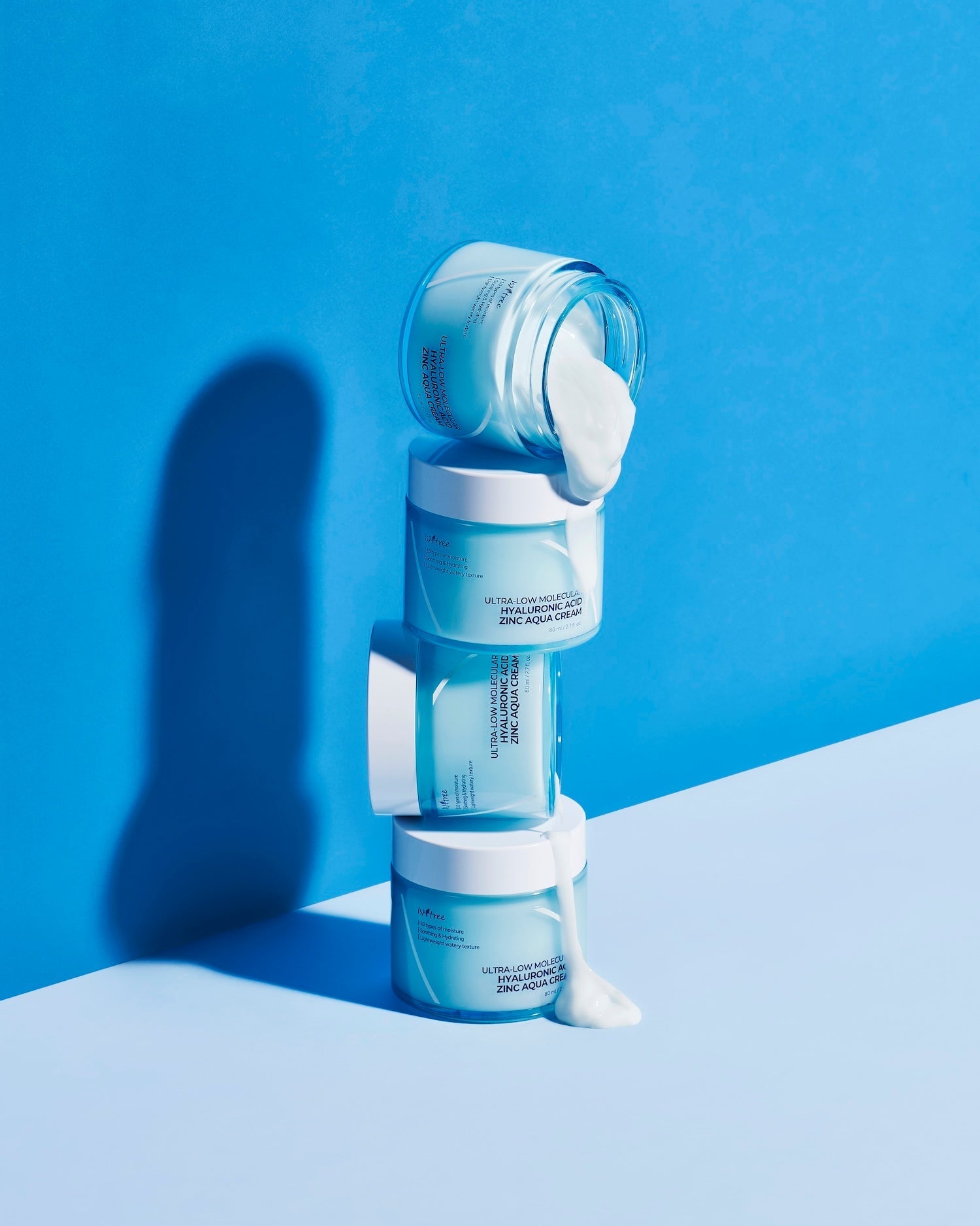 Model patting zinc aqua cream into oily t-zone area