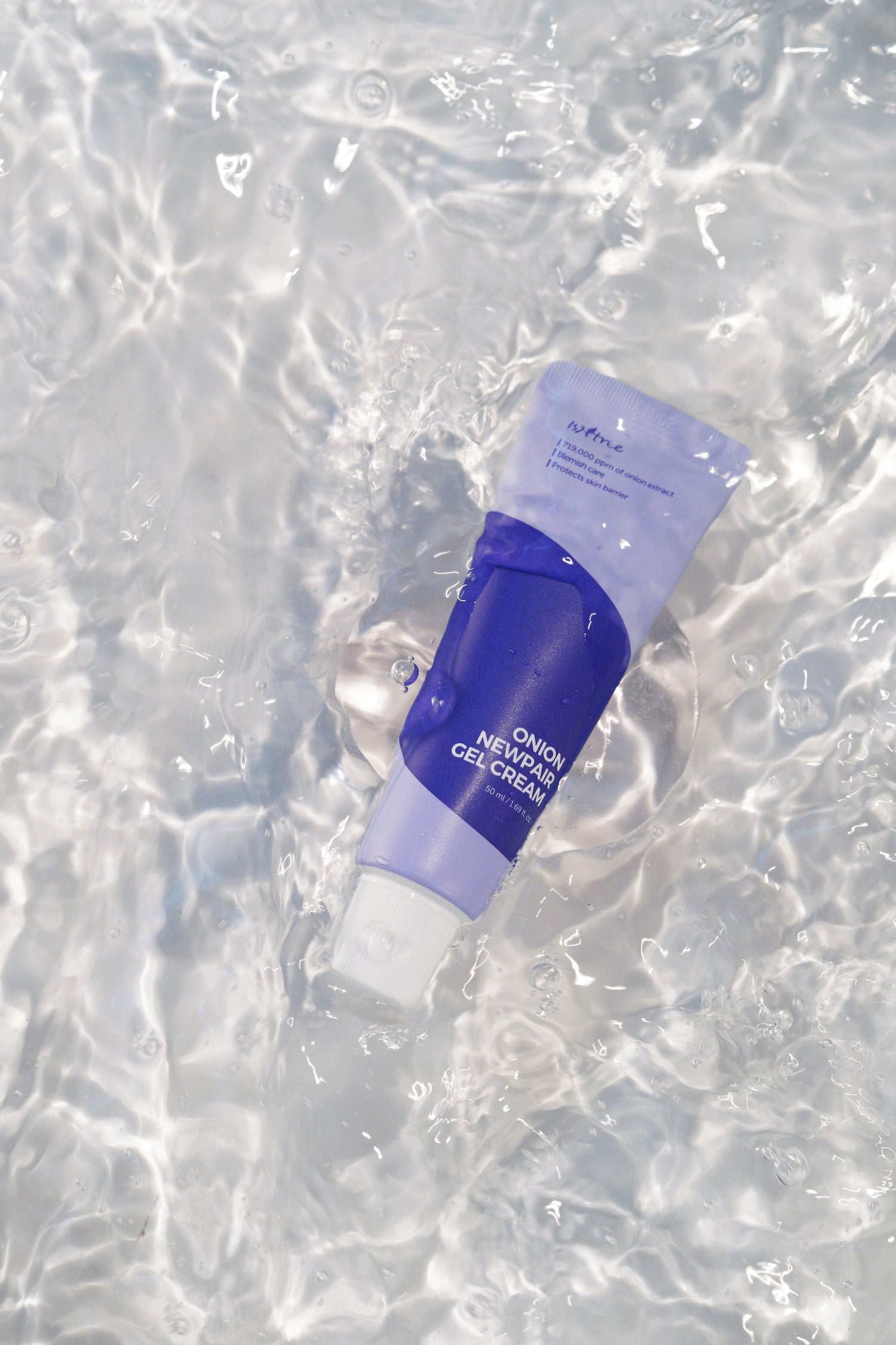Model patting gel cream into skin during evening routine