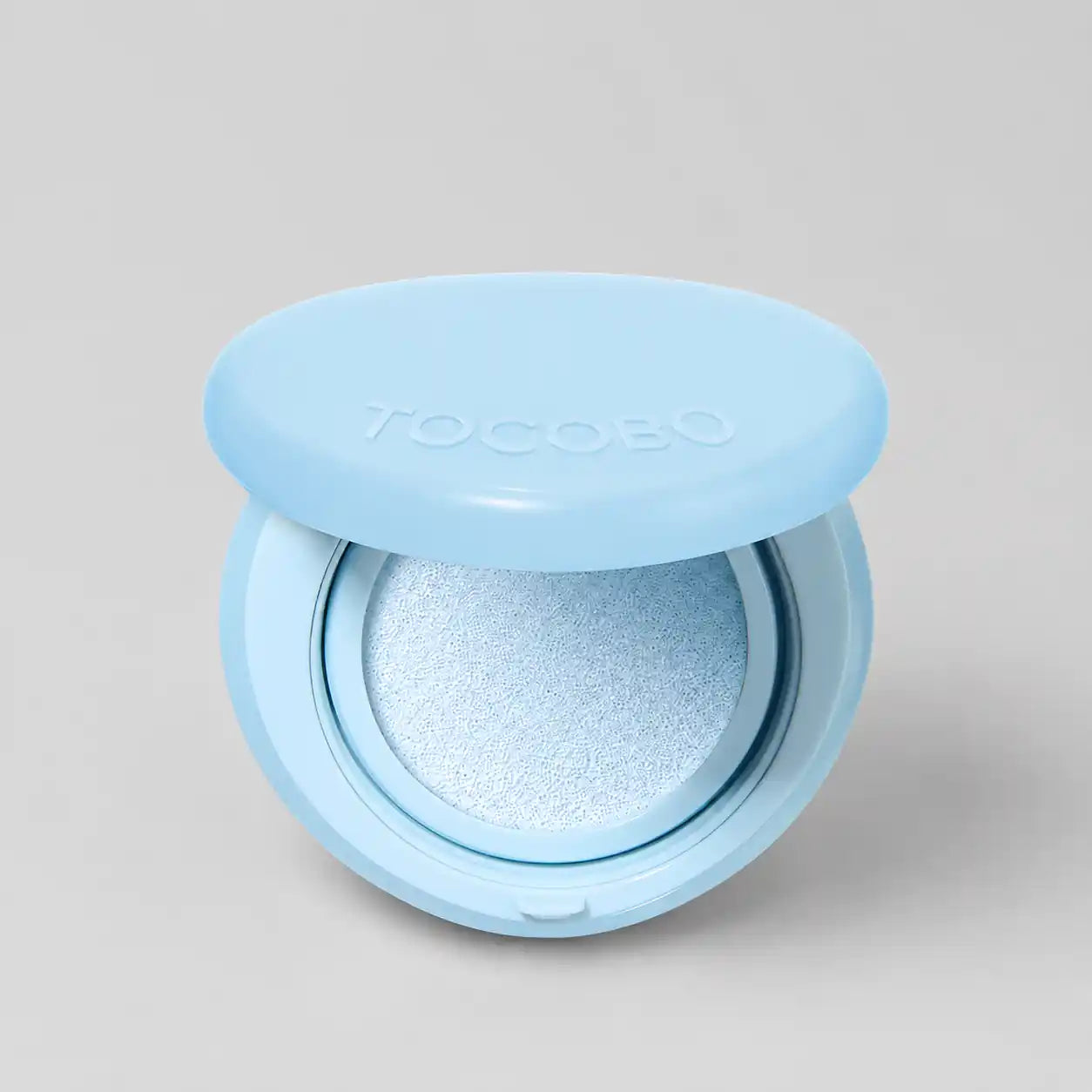 Cushion compact opened showing puff applicator